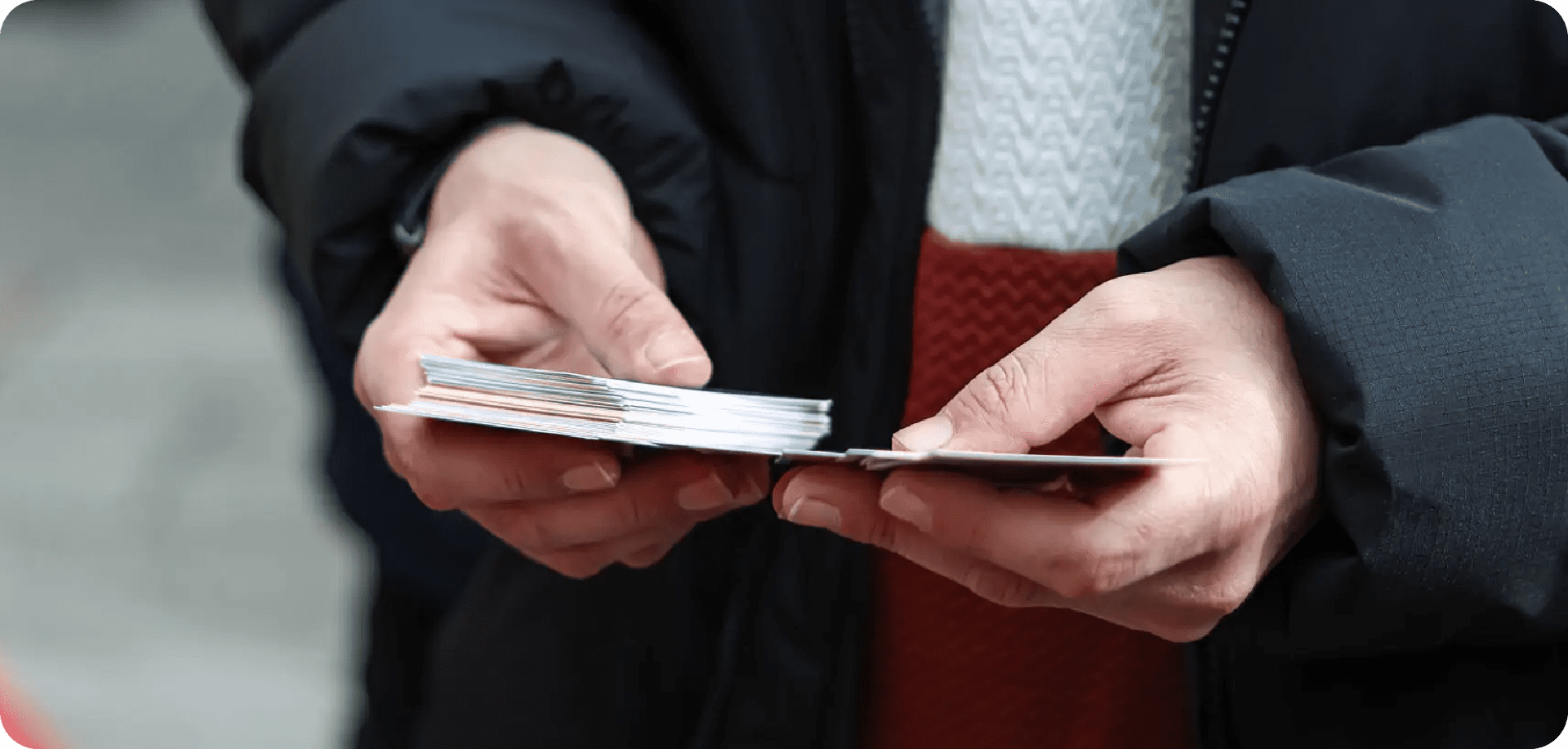 Two people exchanging credit cards in a close-up.